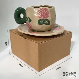 Detail of vintage ceramic coffee cup with green handle on its corrugated packaging box
