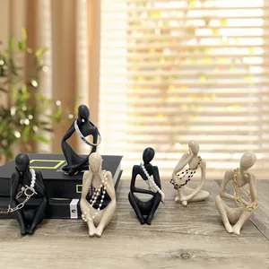 Abstract resin thinker statues used as jewelry organizer for necklaces and earrings