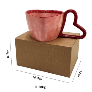 Detail showing red heart-shaped handle on a pink ceramic mug with dimensions and weight info