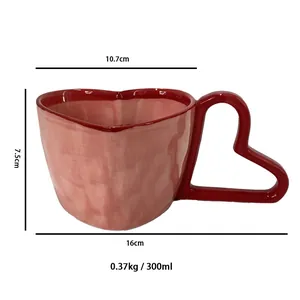 Pink heart-shaped ceramic coffee mug with creative hollow handle and 300ml capacity