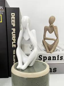 Detail view of abstract thinker sculptures in matte white and sandstone textured finish
