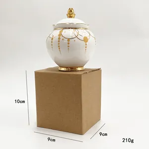 Detail of white ceramic sugar bowl with gold star patterns and golden lid handle