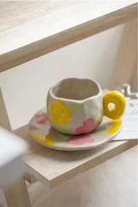 Detailed close-up of a French retro ceramic coffee cup with hand-painted floral patterns