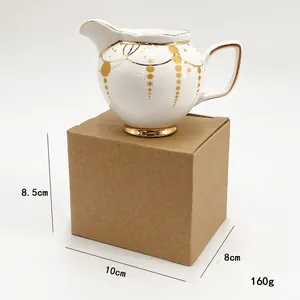 Detailed view of white ceramic cream pitcher with gold trim and exact dimensions