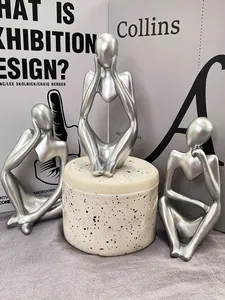 Macro detail of silver abstract thinker sculptures on decorative bases for office decor