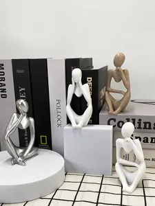 Set of four minimalist thinker sculptures in silver, white, and sandstone resin