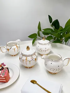 Elegant white ceramic sugar and milk jar set with gold rim for European tea party