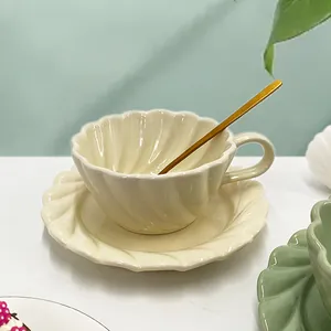 Détail d'un service à café en céramique crème avec texture tourbillon et cuillère