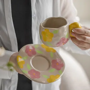 Hand-painted vintage floral ceramic coffee cup and saucer set with yellow thick handle