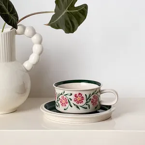 French vintage ceramic coffee cup and saucer set with floral pattern and green interior
