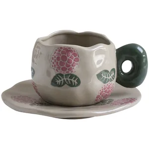 French vintage ceramic coffee cup and saucer set with pink floral relief and green handle