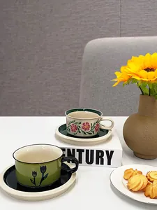 Detailed view of French vintage ceramic coffee cups with floral patterns and matching saucers
