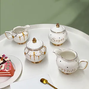Elegant Nordic ceramic sugar bowl and milk jug set with gold trim and minimalist floral patterns