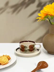 Close-up of retro ceramic coffee cup and saucer with vintage fruit patterns and warm lighting