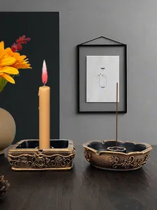 Detailed close-up of vintage gold floral embossed candle holder and incense burner set
