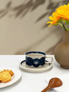 Detail view of retro ceramic coffee cup with blue floral pattern for high-end tea time