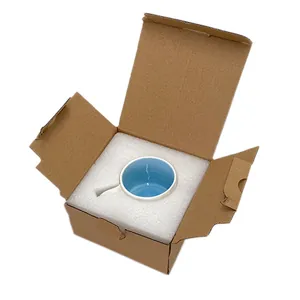 Detail view of a ceramic coffee mug with lake blue interior in protective foam packaging
