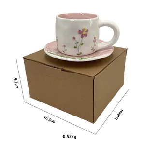 Macro detail of floral ceramic coffee cup set with dimensions on packaging box