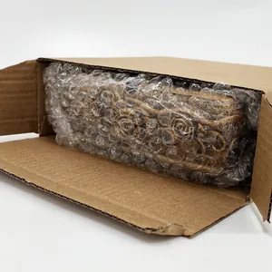 Detail of rose embossed vintage gold trinket box safely packed in bubble wrap and carton