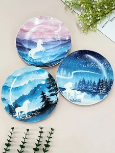 Dettaglio di piatti nordici in ceramica con motivi ad acquerello di unicorni e scene d'arte