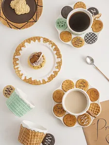 Detailed view of mint green waffle mug and realistic cookie-shaped ceramic plate