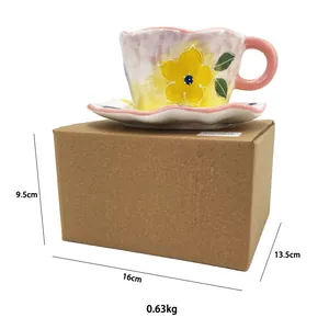 Détail de l'ensemble tasse et soucoupe en céramique peinte avec fleurs sur emballage