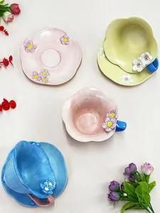 Top view of floral ceramic coffee cup and saucer set with 3D embossed petal details