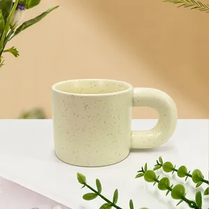 Nordic minimalist speckled ceramic coffee mug with a creative thick handle and cream finish