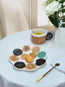 Detail of ceramic biscuit pattern plate and cup set with waffle relief for afternoon tea