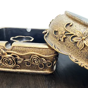 Close-up of vintage golden resin tray with embossed roses and antique finish texture