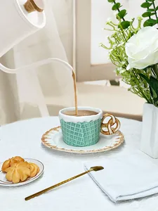 Macro detail of biscuit-shaped ceramic cup with pretzel handle and waffle texture