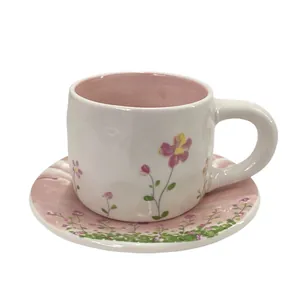 Floral ceramic coffee cup and saucer set with pink marble patterns and hand-painted flowers