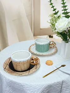 Detail of creative ceramic biscuit coffee cups with pretzel handles and waffle texture