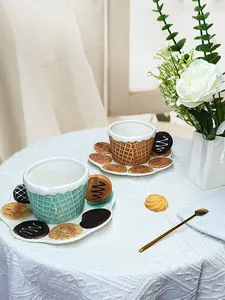 Close-up of ceramic waffle-textured coffee cup with biscuit handle and themed saucer