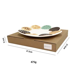 Detail view of round ceramic cookie plate showing 21.5cm dimensions and chocolate accents