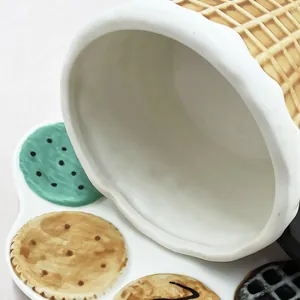 Detailed view of the glazed ceramic cup with waffle texture and biscuit pattern tray