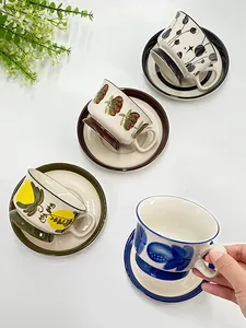 Top view of hand-painted ceramic coffee cup and saucer set with vintage floral patterns