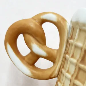 Macro detail of pretzel-shaped handle and waffle-textured ceramic biscuit tableware