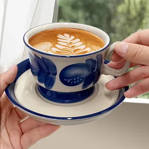 Retro hand-painted ceramic coffee cup and saucer set with elegant blue floral patterns