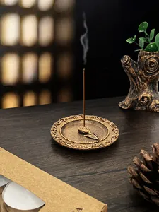 Close-up of vintage bronze incense burner tray with tulip holder and floral relief