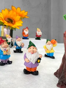 Macro detail of colorful resin garden gnome set featuring a welcome sign and flowers