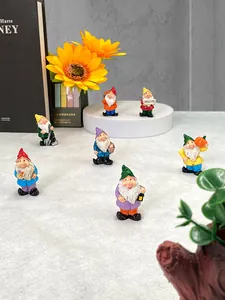 Detail of seven resin garden gnomes featuring a welcome sign and vibrant hand-painted details