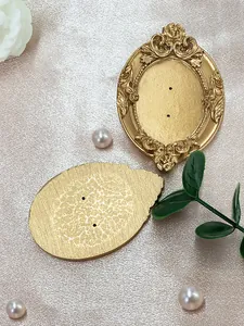 Macro detail of vintage gold oval earring display stand with baroque floral carvings