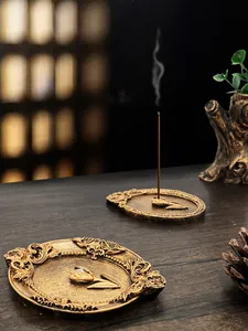 Macro detail of vintage gold incense burner tray with embossed floral patterns