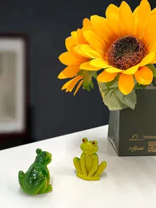 Detailed close-up of small resin frog figurines for creative garden micro-landscapes