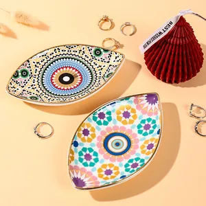 Ceramic evil eye jewelry trays with gold trim and bohemian star patterns for home decor