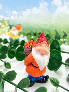 Detailed resin garden gnome figurine carrying a pumpkin basket with harvest theme
