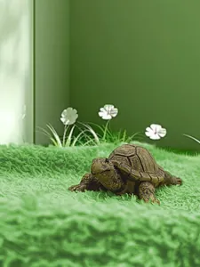 Detailed view of a realistic brown resin turtle figurine with fine shell texture on green moss