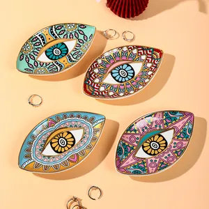Set of four ceramic evil eye jewelry trays with mandala patterns and gold rim finish