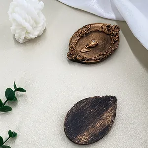 Vintage European style golden relief tray featuring tulip design and ornate scroll texture